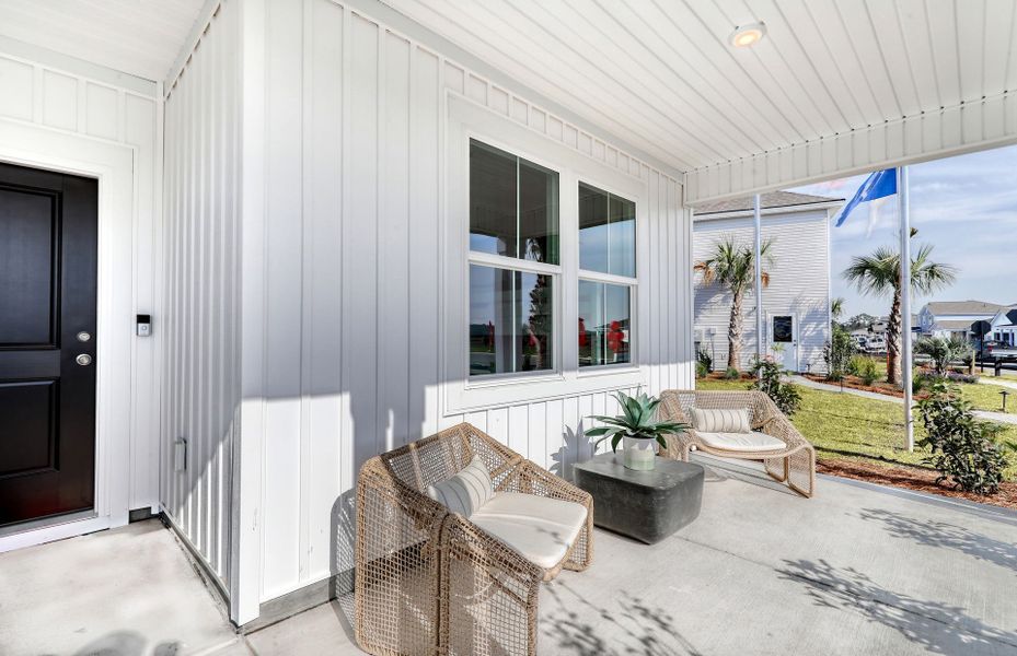 A cozy front porch with space to place outside furniture. Model Home Representation.