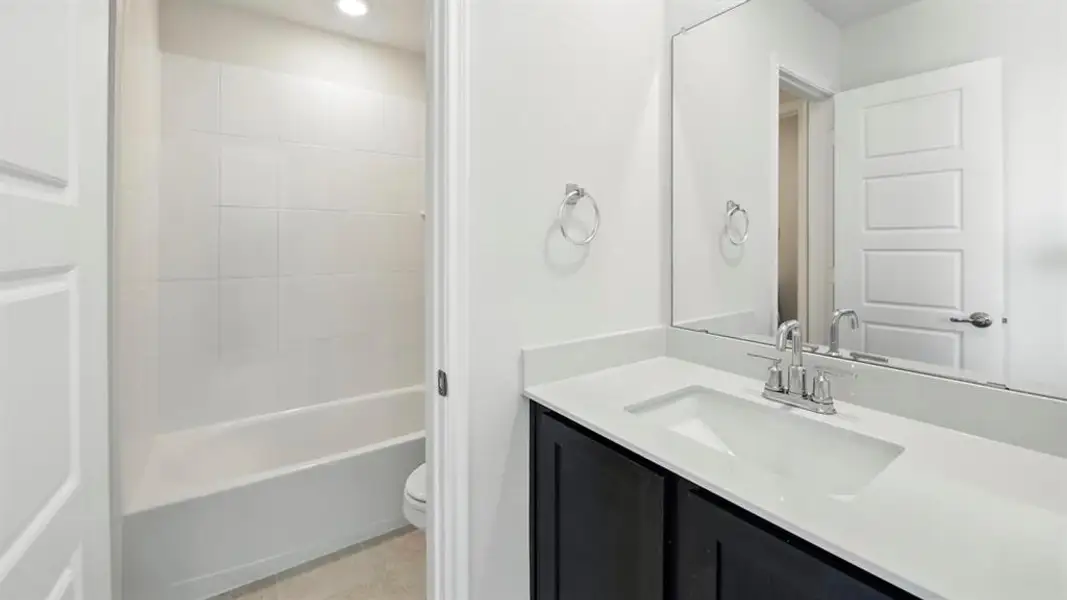 Bathroom with vanity and light tile patterned floors