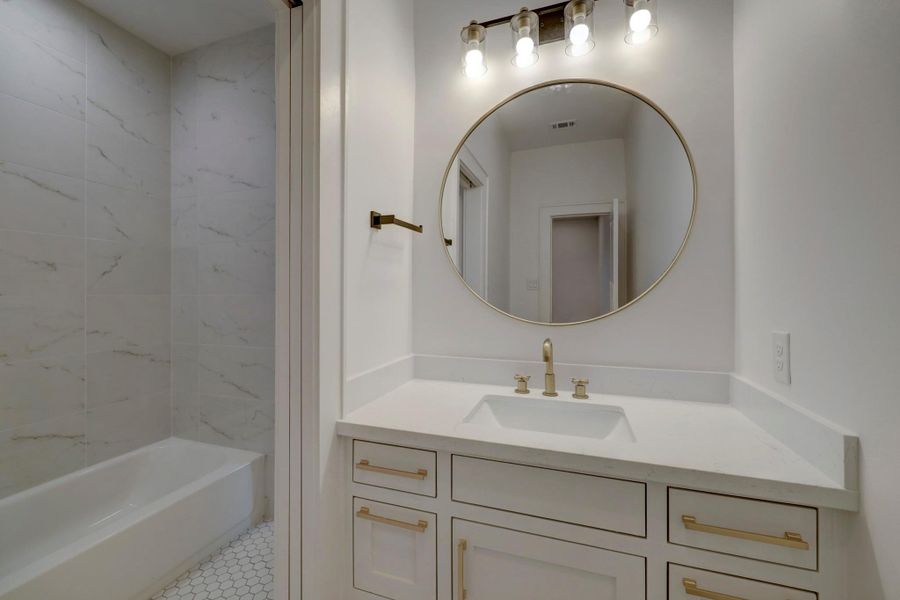 Jack and Jill bathroom but with separate vanity areas*photos are of a previously constructed home by the builder. 1527 Hewitt may have different selections at builders sole discretion. These photos are not meant to be an exact representation of 1527 Hewitt.