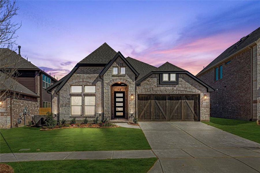 Front exterior of a new home in Painted Tree Woodland District 50, McKinney, TX, highlighting curb appeal (Image 1).