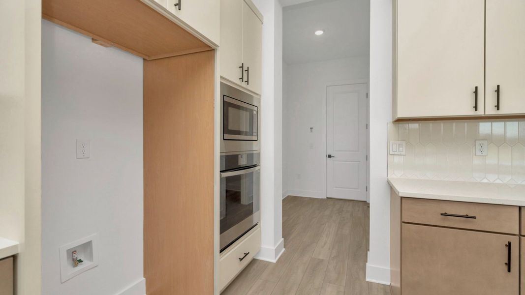 The Kitchen of a DRB Homes Grand Hawk which is offered as a home plan at Serengeti in Spring Hill, FL.