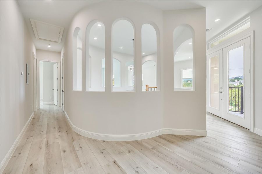 Hallway with light hardwood / wood-style floors