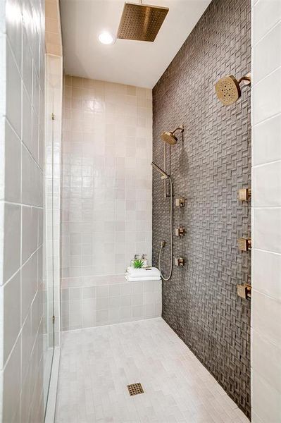 Full bath with a stall shower, recessed lighting, tile patterned floors, and tile walls