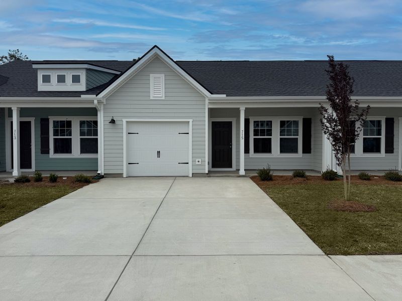 Front exterior of a new home in Blue Heron Retreat, Little River, SC, highlighting curb appeal (Image 1). Front exterior of a new home in Blue Heron Retreat, Little River, SC, highlighting curb appeal (Image 1).