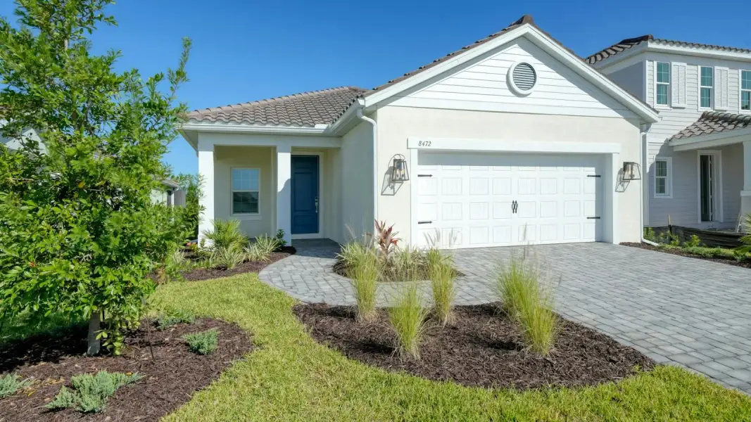 Front exterior of a new home in Windward Real Estate and Homes for Sale in Sarasota, FL - Neal Communities, Sarasota, FL, highlighting curb appeal (Image 1). Front exterior of a new home in Windward Real Estate and Homes for Sale in Sarasota, FL - Neal Communities, Sarasota, FL, highlighting curb appeal (Image 1).