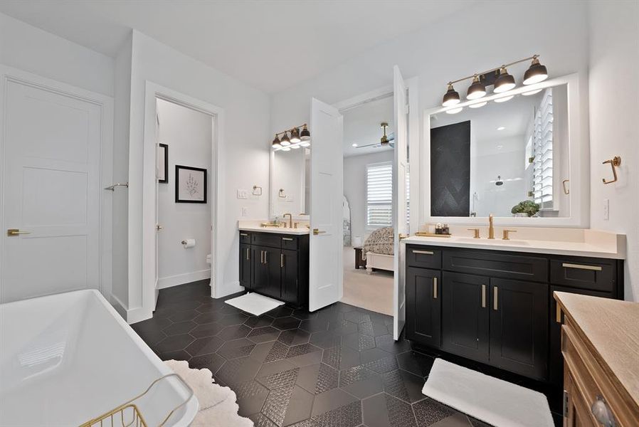 Dual vanities with dark cabinetry and light countertops Dual vanities with dark cabinetry and light countertops