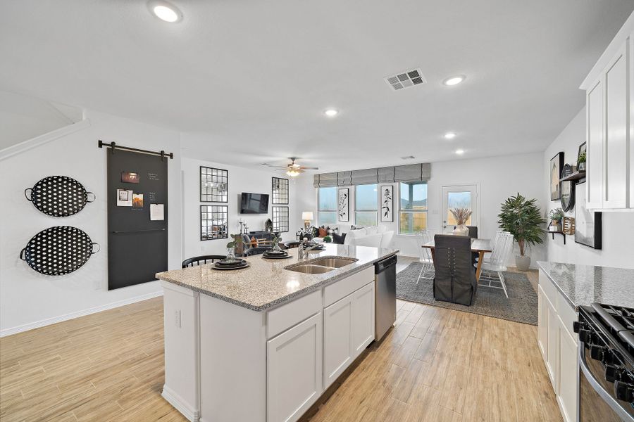 A kitchen with white cabinets.