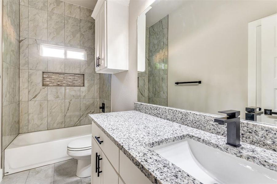 Bathroom with vanity and bathing tub / shower combination