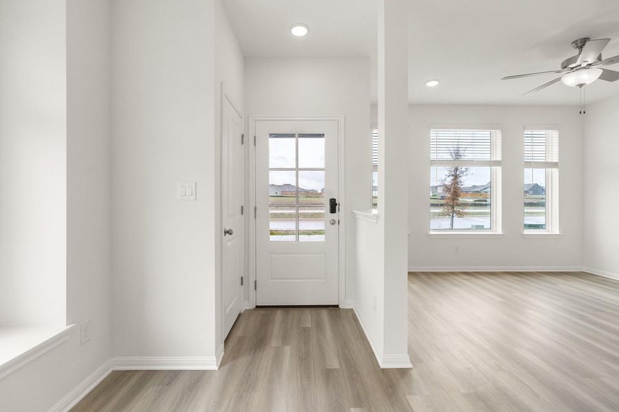 Doorway with ceiling fan, wood finished floors, and recessed lighting