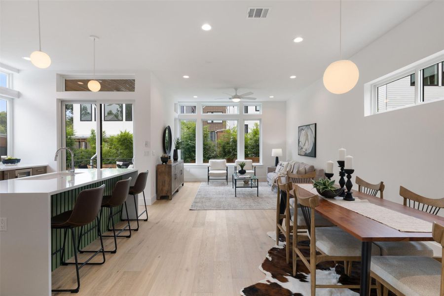 Dining room with light wood-style flooring, recessed lighting, and ceiling fan Dining room with light wood-style flooring, recessed lighting, and ceiling fan