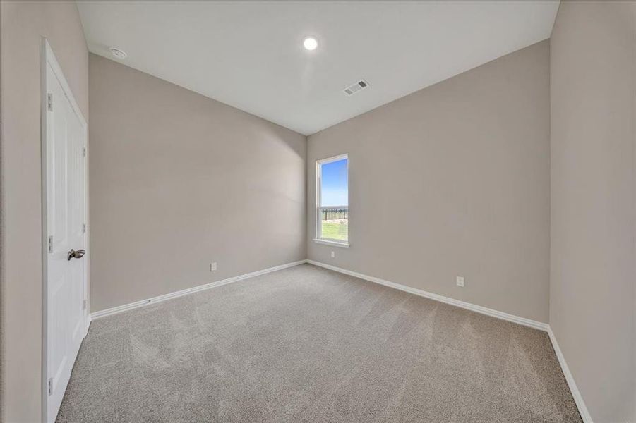 Unfurnished room featuring carpet flooring and baseboards Unfurnished room featuring carpet flooring and baseboards