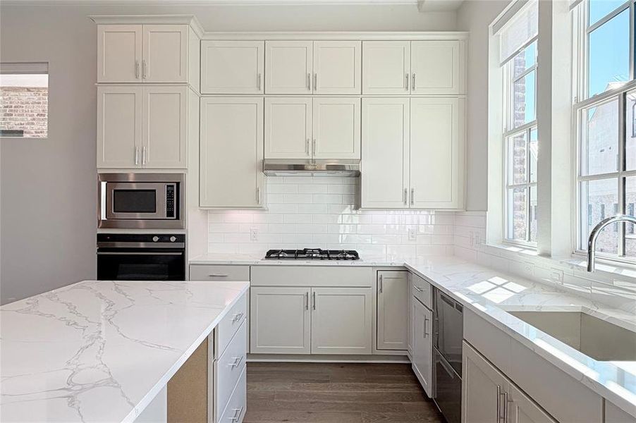 Progress photo of actual unit. Island features opening for wine or beverage fridge.