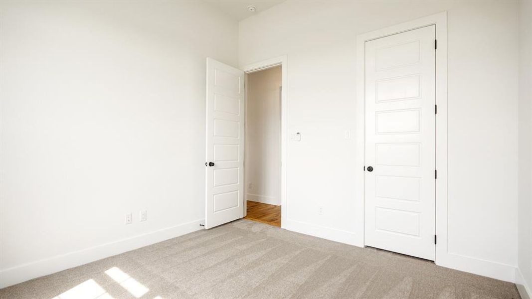 Unfurnished bedroom featuring light colored carpet and a closet