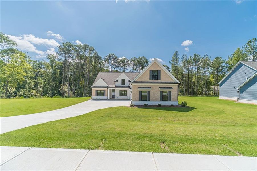 Front exterior of a new home in , Loganville, GA, highlighting curb appeal (Image 20). Front exterior of a new home in , Loganville, GA, highlighting curb appeal (Image 20).