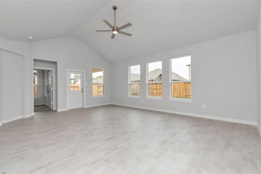 Take another glimpse into the heart of the home with this additional view of the family room—a sprawling space ready to accommodate all your gatherings. Sample photo of completed home with similar floor plan. As-built interior colors and selections may vary.