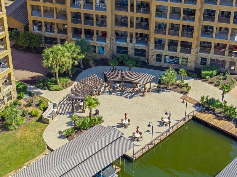 Lakeside living beckons with private boat slips, dining patios, and serene pergolas amidst lush landscaping.