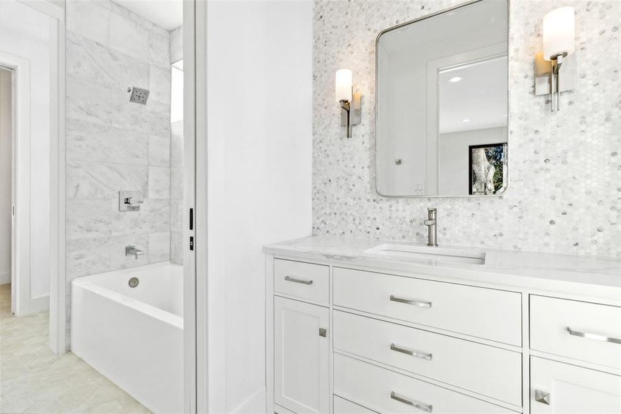 Jack and Jill bathroom with tub-shower combo, dual access, and sleek, modern finishes.