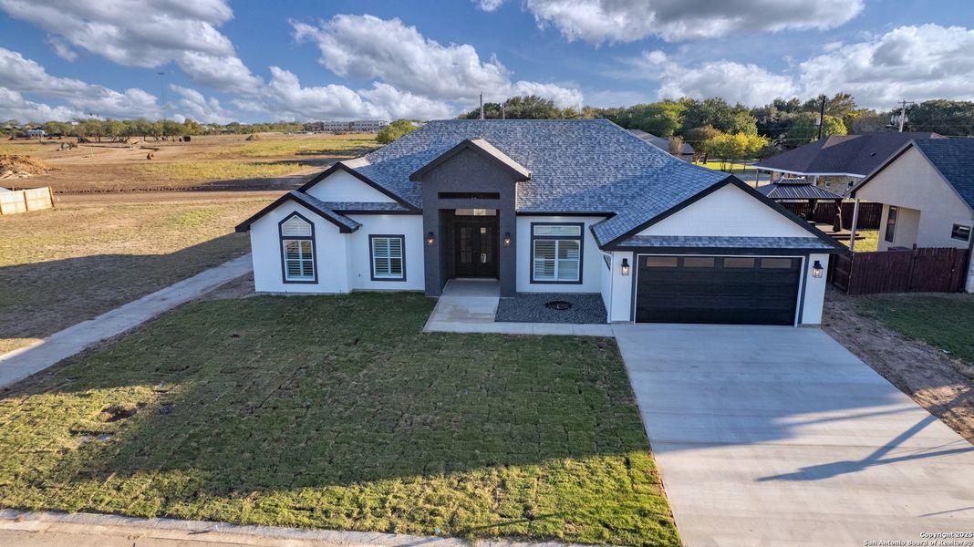 Front exterior of a new home in , Uvalde, TX, highlighting curb appeal (Image 21).