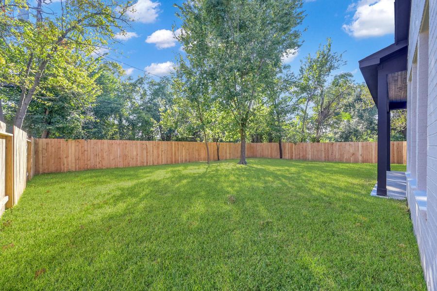 Spacious backyard with mature trees and privacy fencing. Spacious backyard with mature trees and privacy fencing.