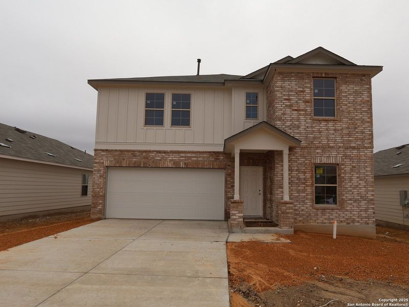 Front exterior of a new home in Hunters Ranch, San Antonio, TX, highlighting curb appeal (Image 1). Front exterior of a new home in Hunters Ranch, San Antonio, TX, highlighting curb appeal (Image 1).