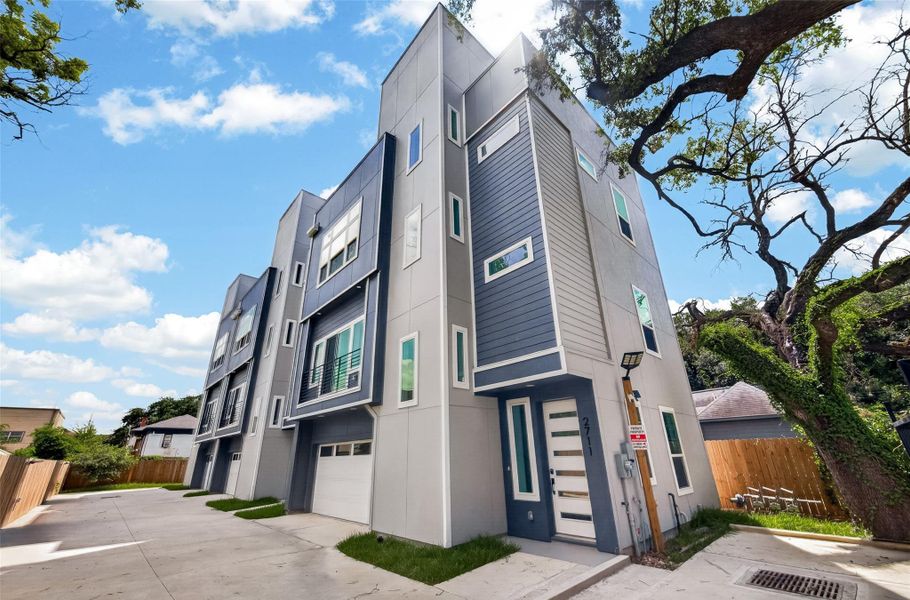 Modern multi-story townhouse with a sleek exterior design, featuring large windows and a contemporary color scheme. The property includes a driveway and is surrounded by a mix of natural greenery and urban elements, offering a blend of privacy and accessibility. Modern multi-story townhouse with a sleek exterior design, featuring large windows and a contemporary color scheme. The property includes a driveway and is surrounded by a mix of natural greenery and urban elements, offering a blend of privacy and accessibility.