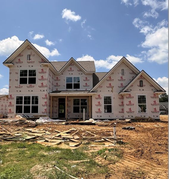 New construction residence featuring a multi-gable roofline, multiple window placements, and a covered porch entry New construction residence featuring a multi-gable roofline, multiple window placements, and a covered porch entry