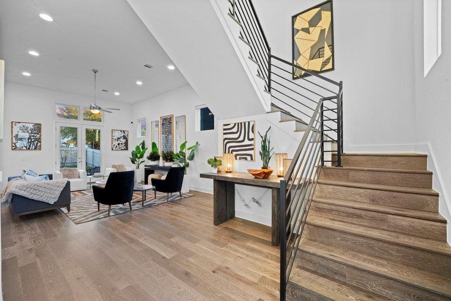 Stairway with recessed lighting, wood finished floors, and a ceiling fan