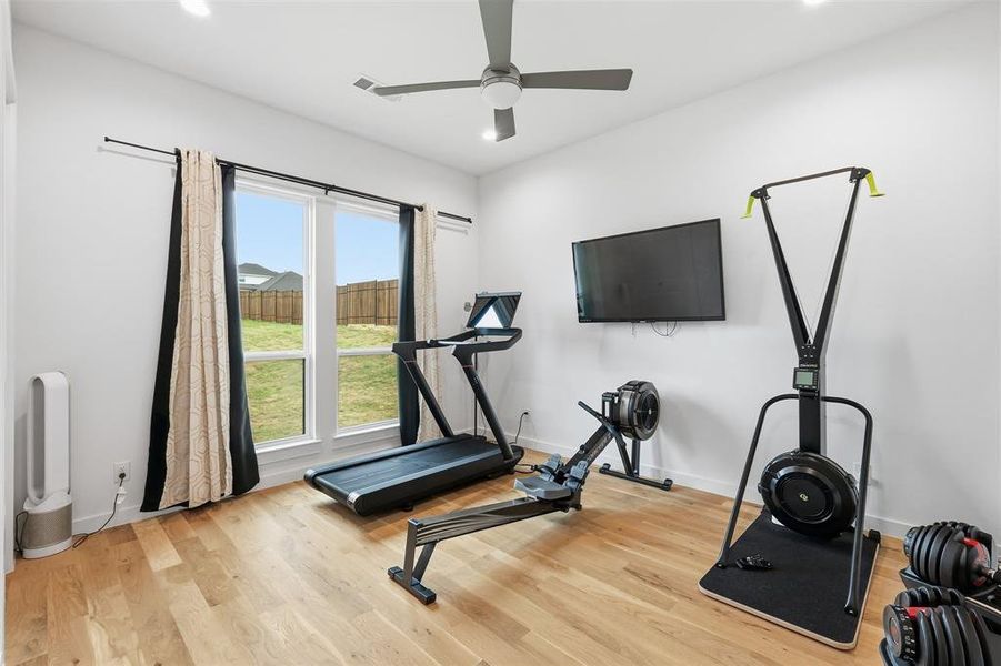 Exercise room featuring recessed lighting, light wood-style floors, and ceiling fan