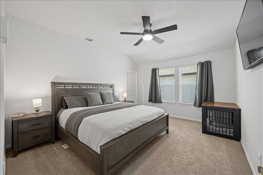 Bedroom featuring carpet flooring, a ceiling fan, and lofted ceiling Bedroom featuring carpet flooring, a ceiling fan, and lofted ceiling