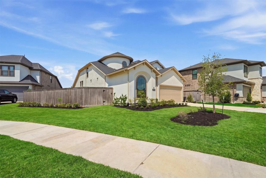 Front exterior of a new home in Bridgeland 45', 50', 70', Cypress, TX, highlighting curb appeal (Image 1). Front exterior of a new home in Bridgeland 45', 50', 70', Cypress, TX, highlighting curb appeal (Image 1).