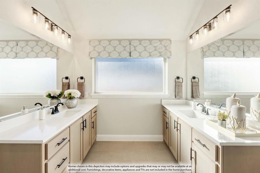Bathroom with dual vanities, white countertops, light wood cabinets, and frosted windows on each side