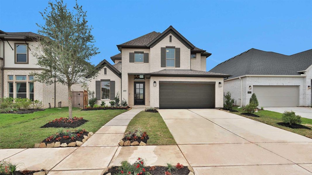 Front exterior of a new home in Sienna, Missouri City, TX, highlighting curb appeal (Image 1). Front exterior of a new home in Sienna, Missouri City, TX, highlighting curb appeal (Image 1).