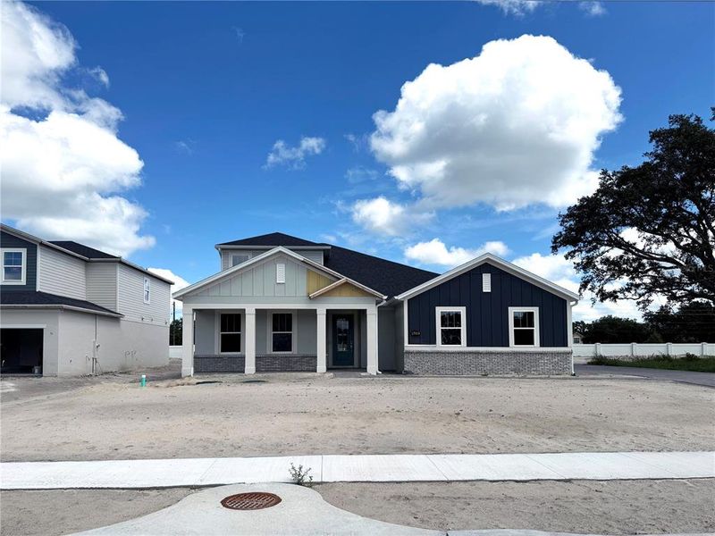 Front exterior of a new home in Solace at Corner Lake, Orlando, FL, highlighting curb appeal (Image 29).