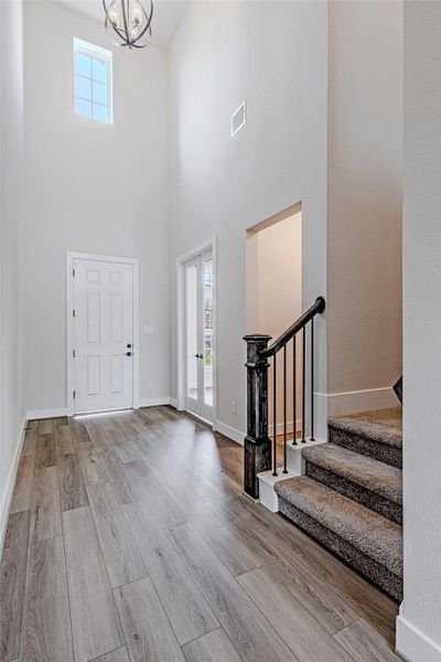 Bright foyer with high ceilings and natural light, creating an open and airy first impression.