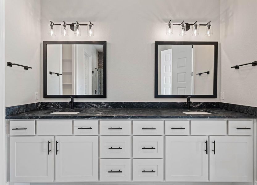 Bathroom featuring double vanity and a sink Bathroom featuring double vanity and a sink