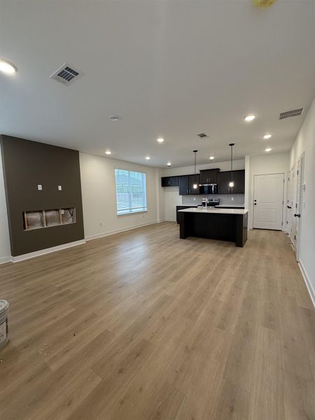 Unfurnished living room with light wood finished floors and recessed lighting