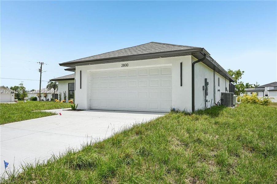 Front exterior of a new home in , Cape Coral, FL, highlighting curb appeal (Image 24). Front exterior of a new home in , Cape Coral, FL, highlighting curb appeal (Image 24).