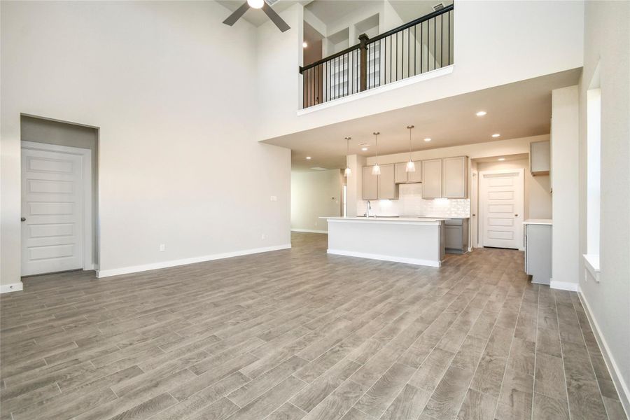 All of this overlooks your expansive family room, creating a perfect space forculinary delights and family gatherings. Sample photo of completed home with similar floor plan. Actual colors and selections may vary.