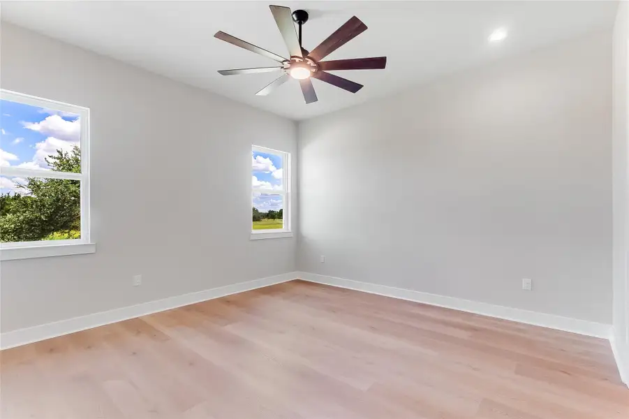 Spare room with light wood-style floors, ceiling fan, and recessed lighting