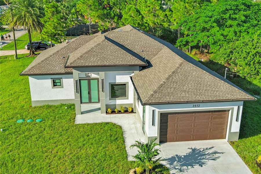 Front exterior of a new home in , Lehigh Acres, FL, highlighting curb appeal (Image 21).