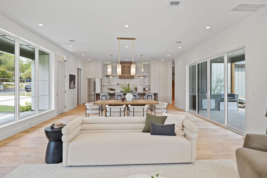 Living area with recessed lighting and light wood-style flooring Living area with recessed lighting and light wood-style flooring