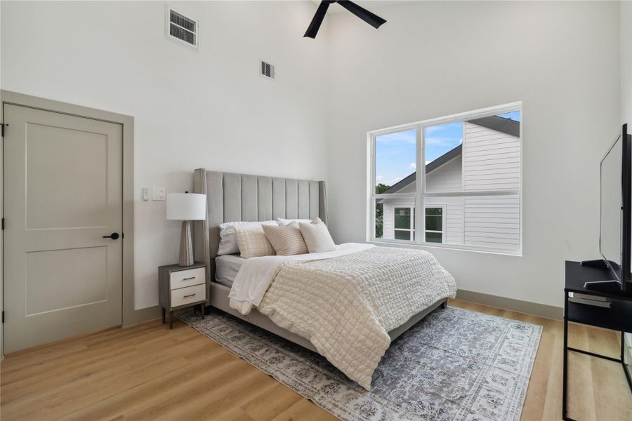 Vaulted ceilings with a modern fan overhead add volume and airiness, enhancing the sense of space and stillness.