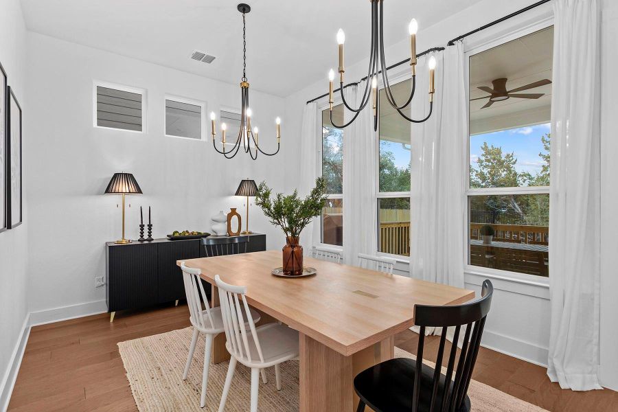 Dining room with dark wood-type flooring and ceiling fan