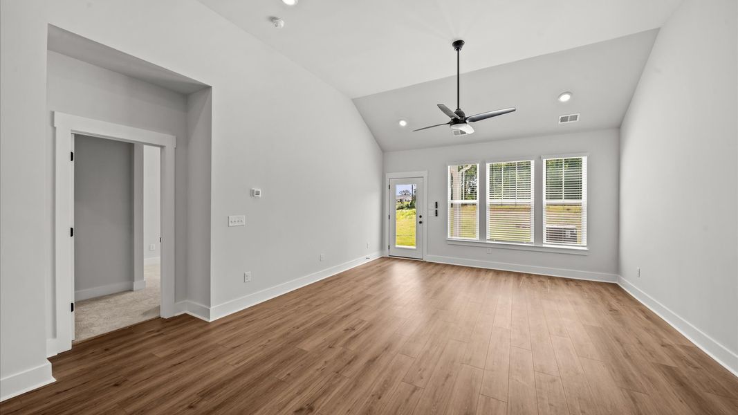 Exceptional family space featuring two-story ceilings, hardwood flooring, and tasteful finishes throughout