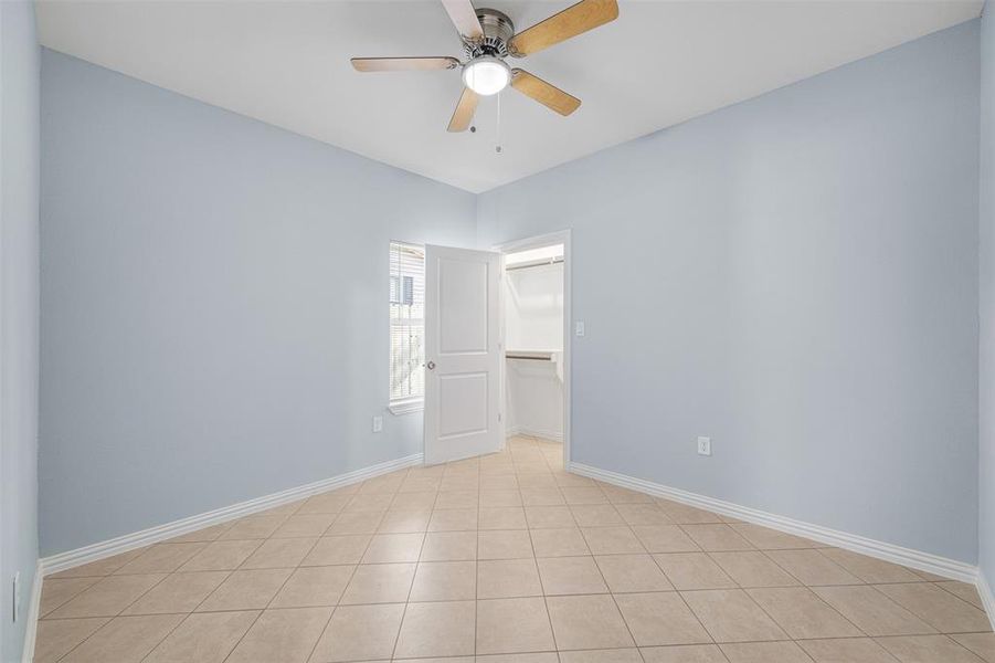 Unfurnished room featuring ceiling fan and light tile patterned flooring