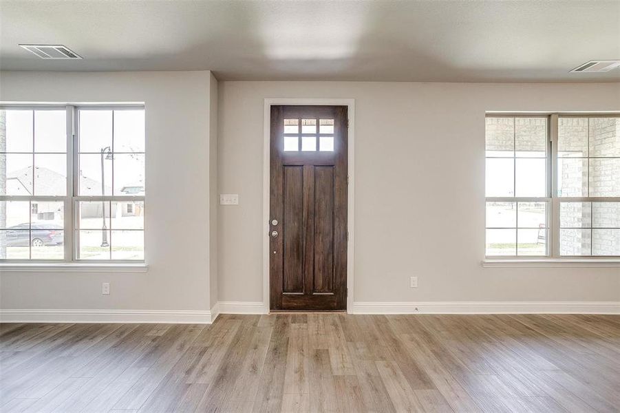 Entrance foyer featuring light wood-style flooring and baseboards