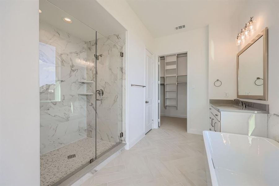 Bathroom featuring vanity and plus walk in shower