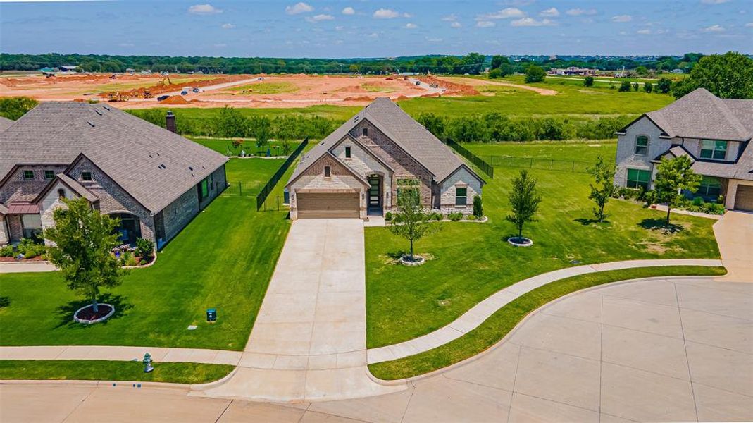 Single-story residence featuring a brick and stone facade, an attached two-car garage, and a concrete driveway