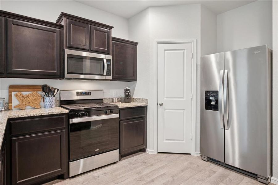 Kitchen featuring stainless steel appliances and a gas range. Kitchen featuring stainless steel appliances and a gas range.