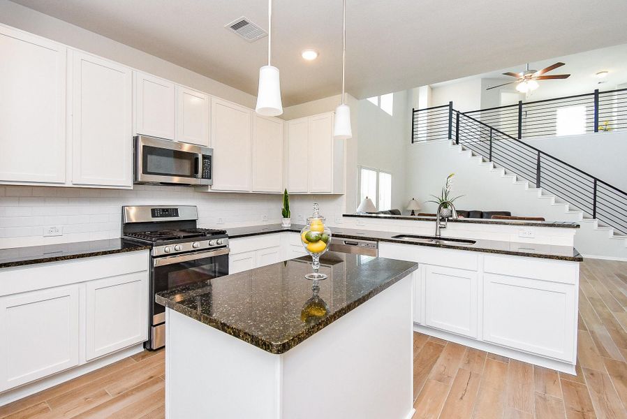 Large kitchen island with pendant lighting. Large kitchen island with pendant lighting.